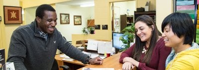 University employee talks with students 
