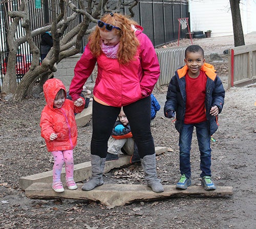 Teacher on a log with children
